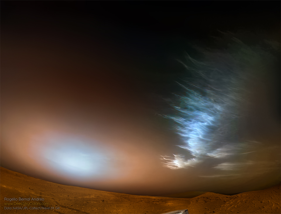 Ice clouds are seen over the surface of Mars on the upper
right. Toward the lower left is a bright spot in the sky which
is likely the Sun rising through Martian dust. 
Please see the explanation for more detailed information.